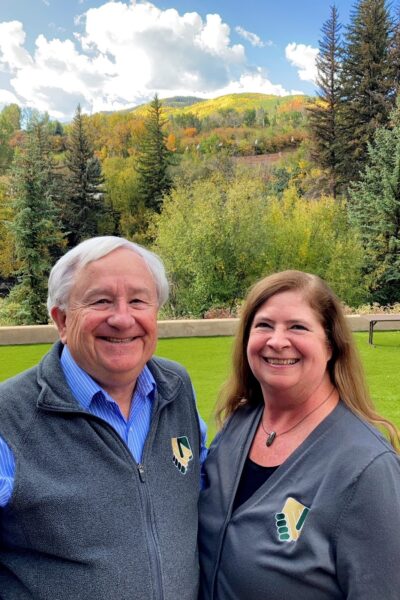 Ed Thomas and Tiger Adolf in front of the Aspen trees at the 16th RMUE Conference